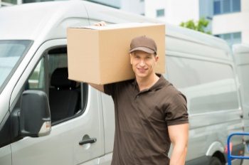 Delivery driver unloading a package