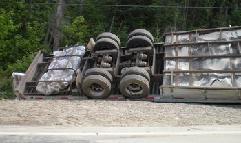 A semi truck turned upside down after truck accident
