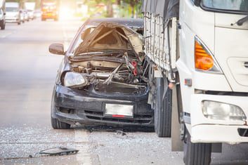 Damaged car after a truck accident
