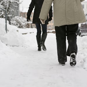 People walk carefully in the snow to avoid injuries