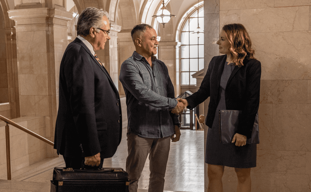 Personal Injury Lawyers Shaking Hands with Client at the Milwaukee Court